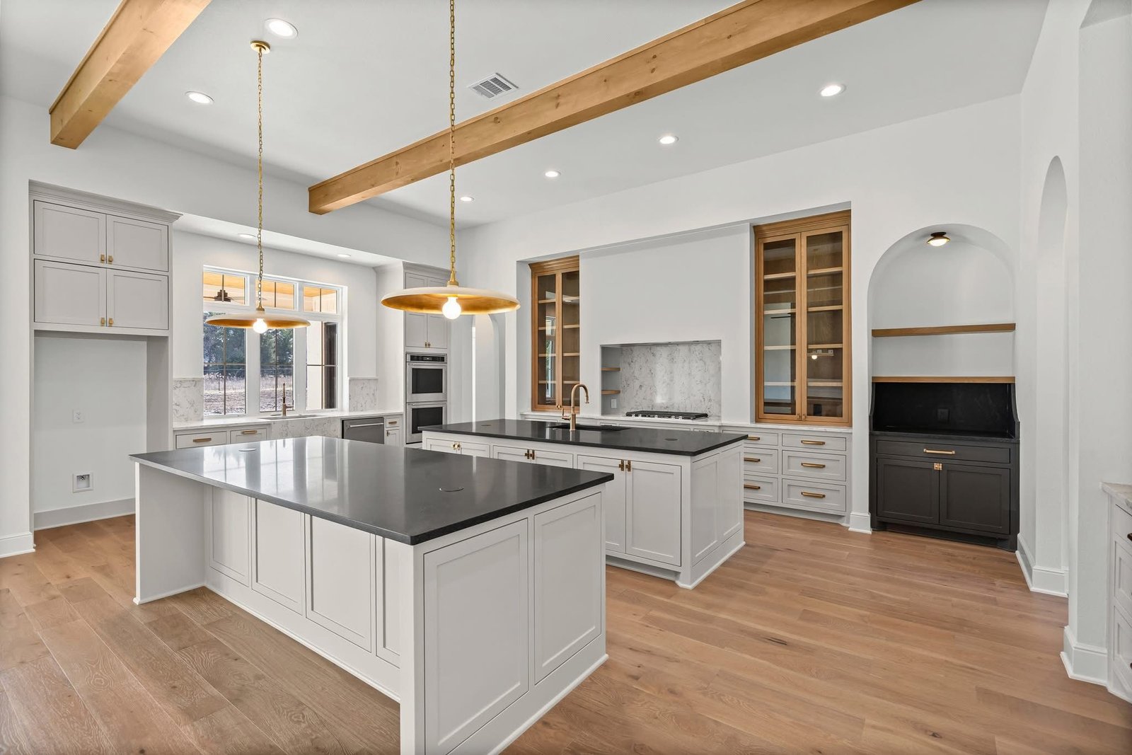 Kitchen with dual islands and wood beams