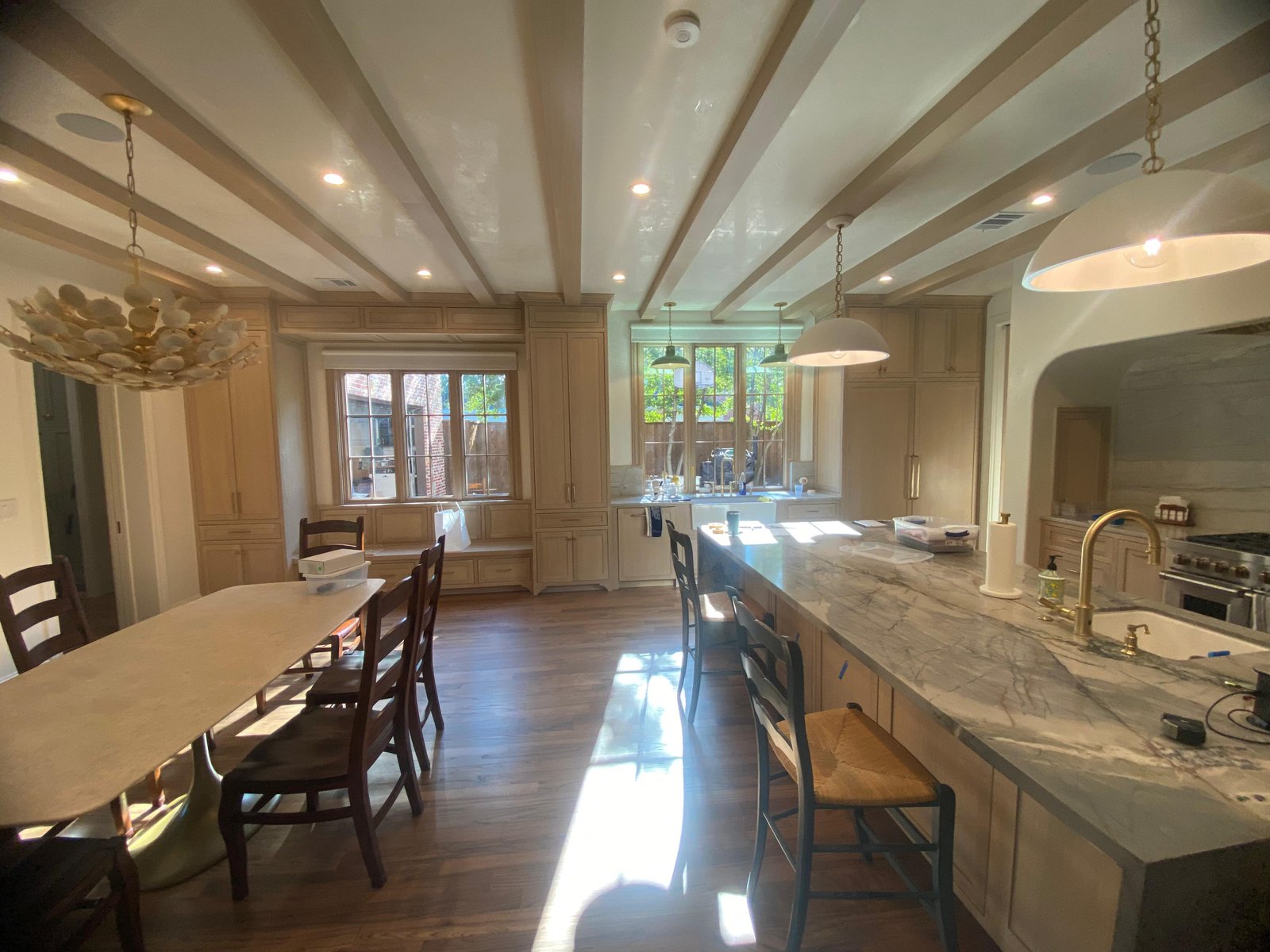 Kitchen with marble island and dining beams