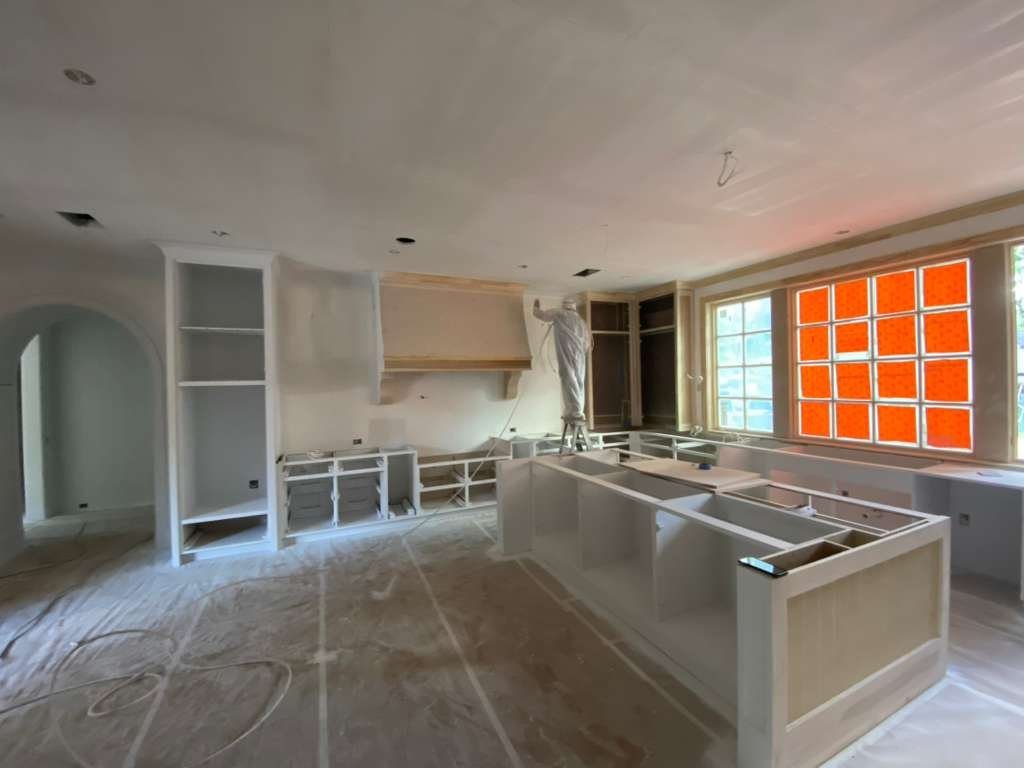 Kitchen with navy blue island and white cabinets